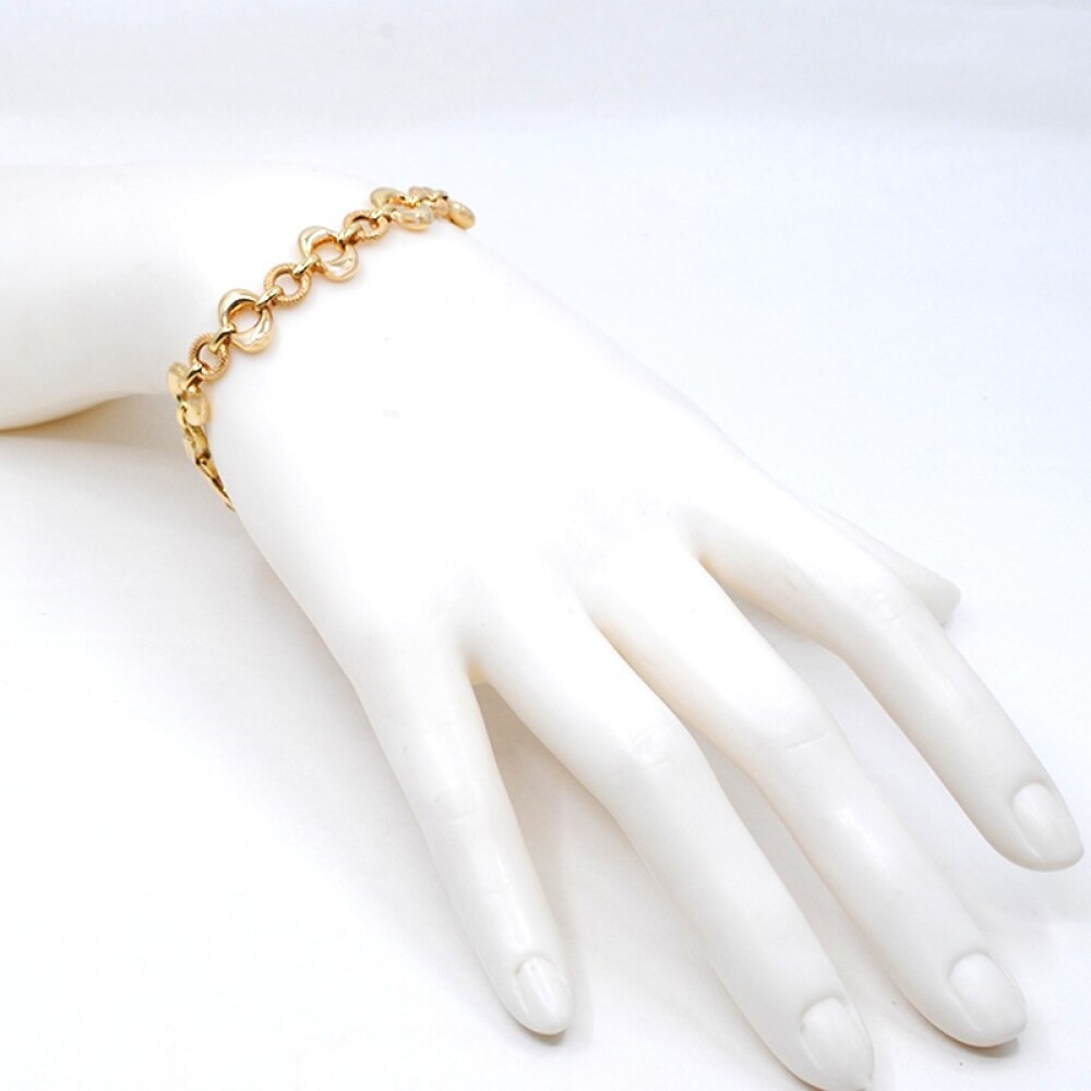 Pulsera en oro 18k con aros lisos y otros labrados Pulsera en oro 18k con aros lisos y otros labrados