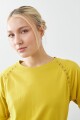 Remera manga raglán con vainillas pistacho