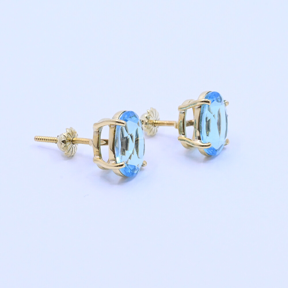 Caravanas oro 18k con topacios azules oval engarce 4 puntas. Caravanas oro 18k con topacios azules oval engarce 4 puntas.