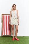Falda corta con nudo beige