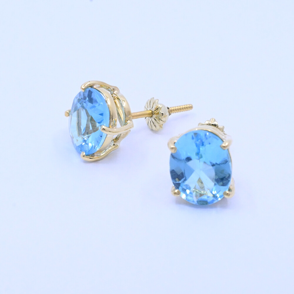 Caravanas oro 18k con topacios azules oval engarce 4 puntas. Caravanas oro 18k con topacios azules oval engarce 4 puntas.