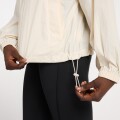 Campera New Balance de Dama - ATHLETIC PACKABLE - WJ41553LIN LINEN