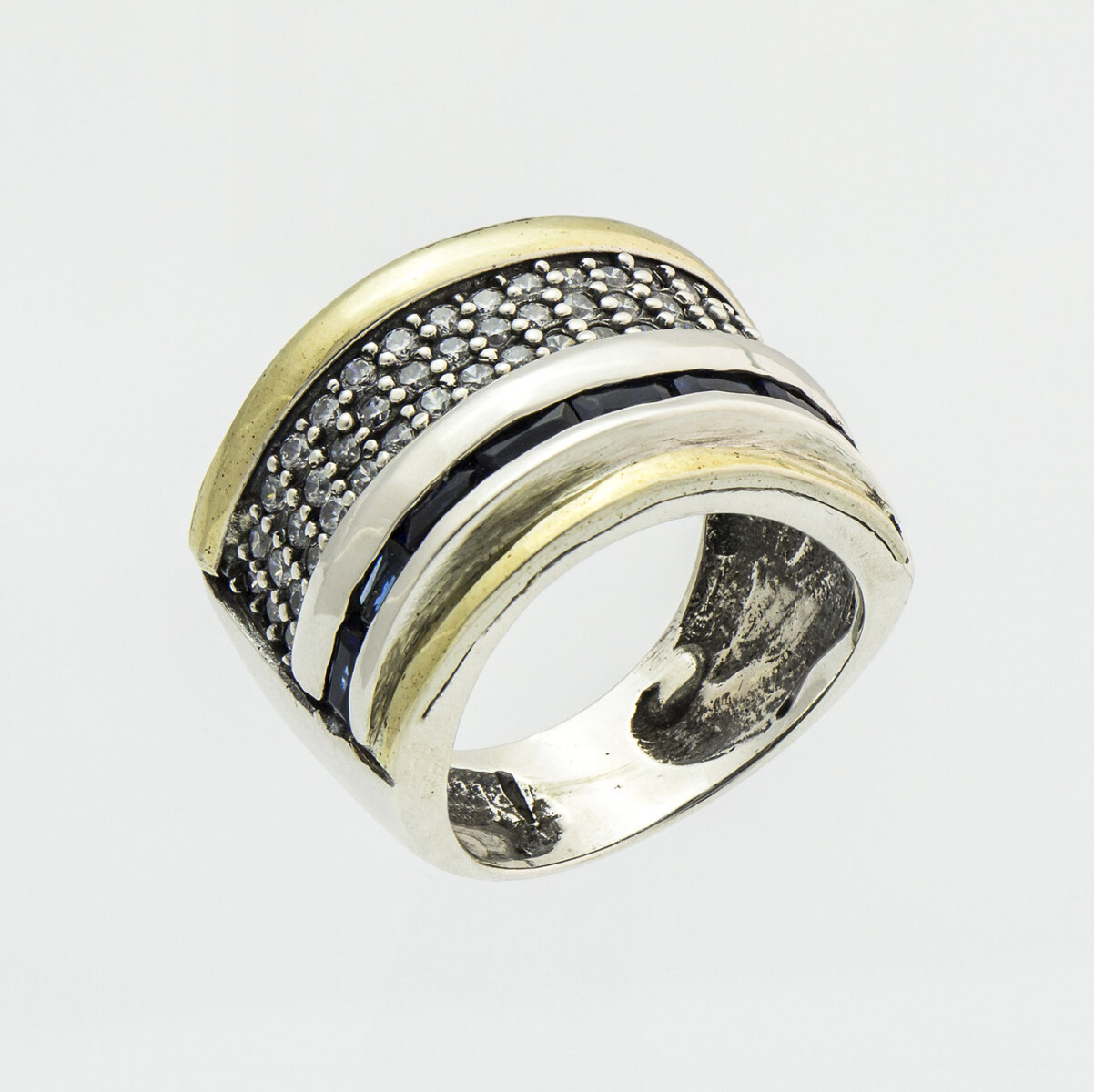 Anillo de plata 925 y double en oro 18k. con circonias blancas y circonias azules imitación zafiro azul. Ancho 1.6 cm. 