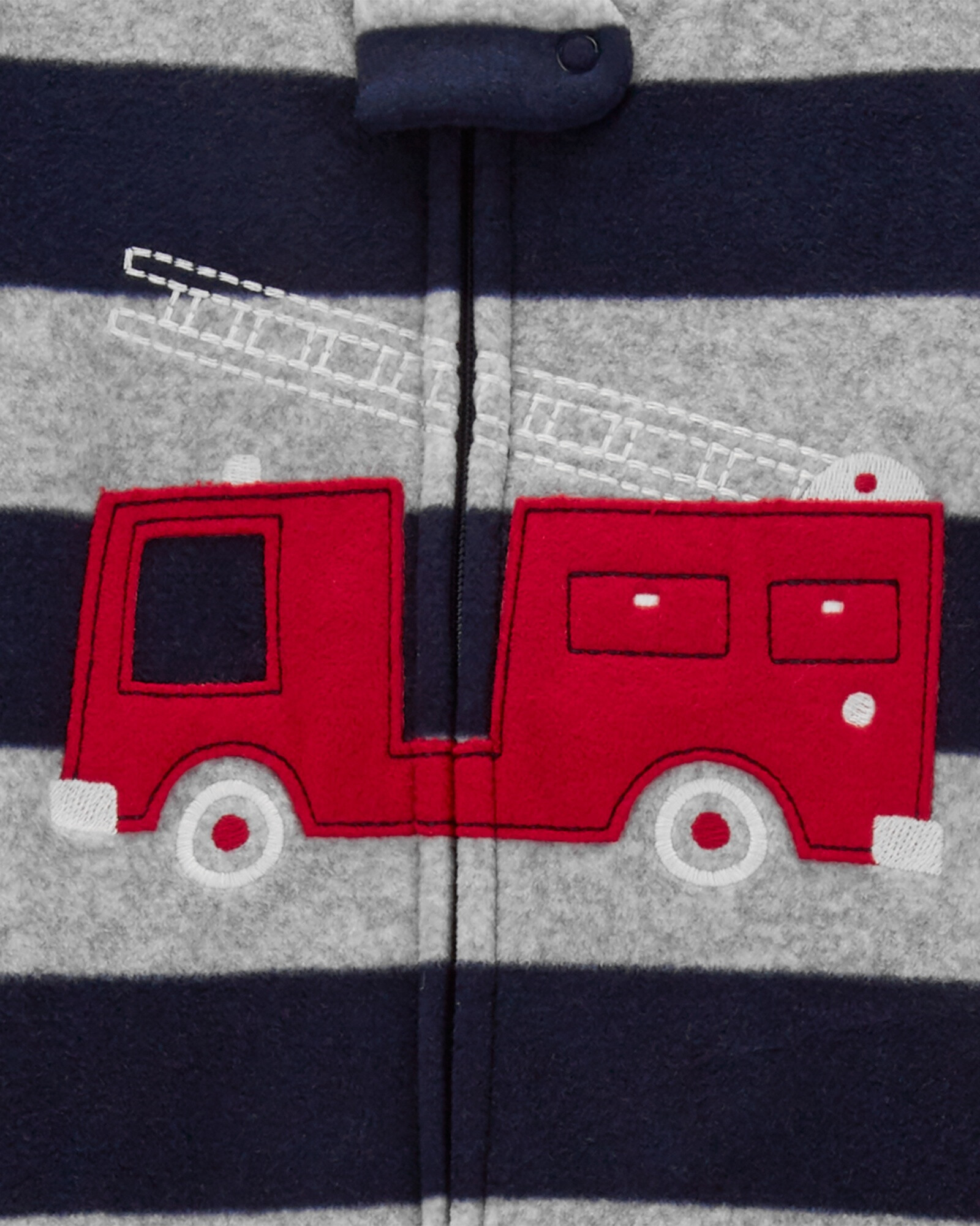 Pijama una pieza de micropolar, con pie, estampa bombero. Talles 12-24M Pijama una pieza de micropolar, con pie, estampa bombero. Talles 12-24M