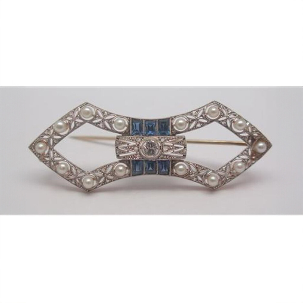 Prendedor oro 18K con perlas naturales, brillante central, diamantes y zafiros sintéticos Prendedor oro 18K con perlas naturales, brillante central, diamantes y zafiros sintéticos