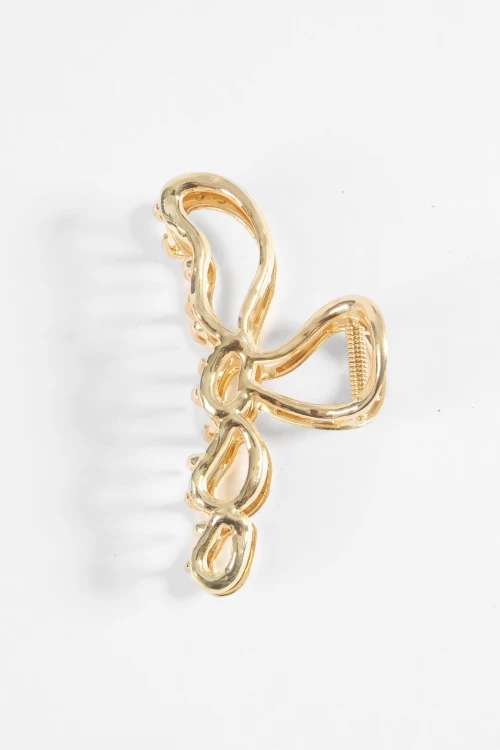 Broche metálico bow dorado