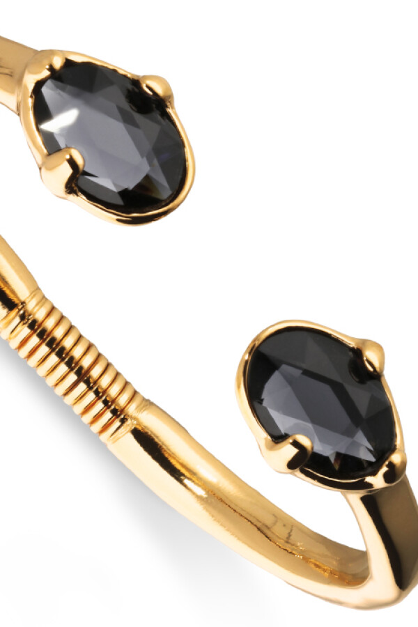 PULSERA RIGIDA DE ALEACIÓN DE METALES BAÑADA EN ORO 18K Y DOS CRISTALES FACETADOS GRISES EN EXTREMOS Pulsera