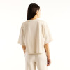 Remera Newbalance Trackside Relaxed mujer WT6272YXLIT Crema