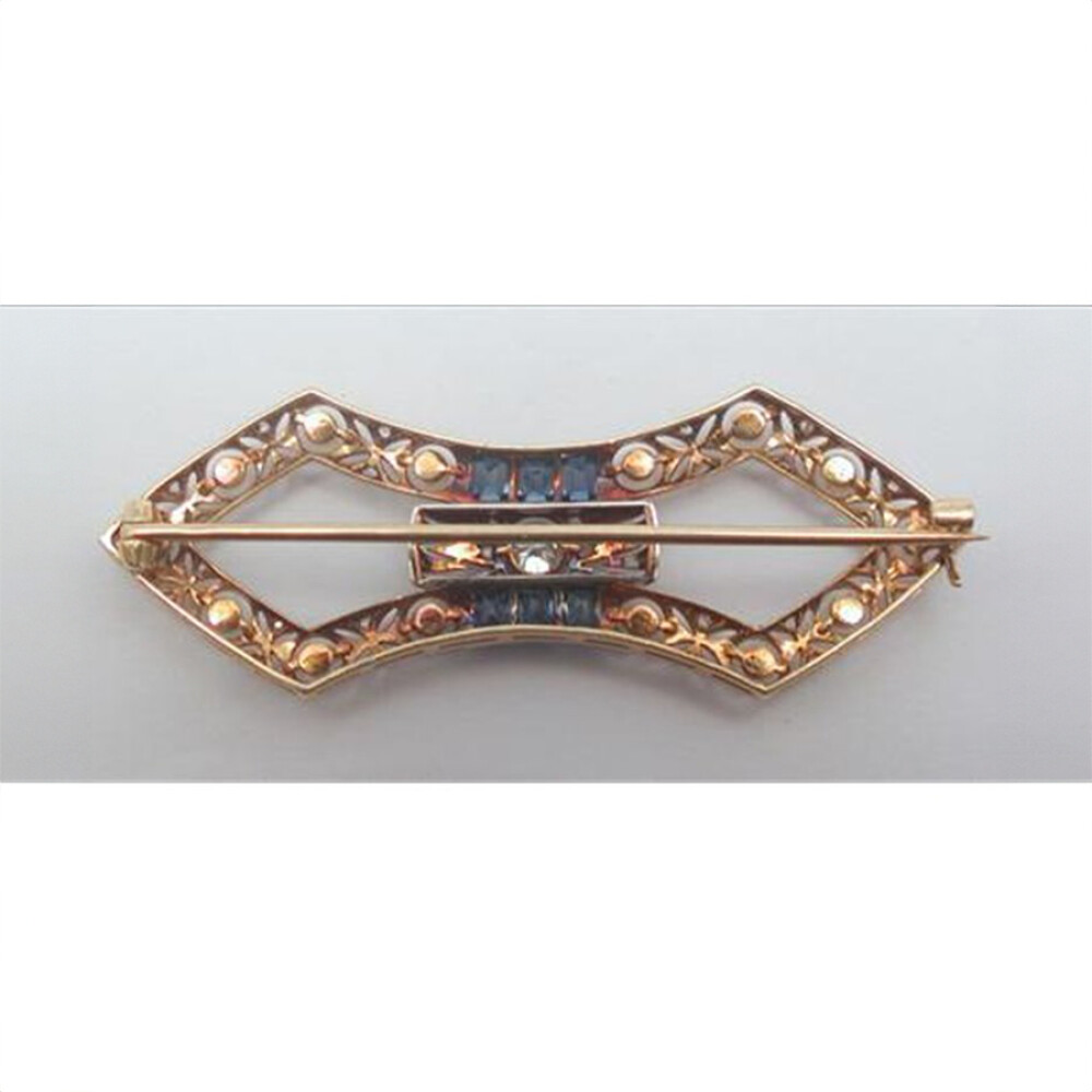 Prendedor oro 18K con perlas naturales, brillante central, diamantes y zafiros sintéticos Prendedor oro 18K con perlas naturales, brillante central, diamantes y zafiros sintéticos
