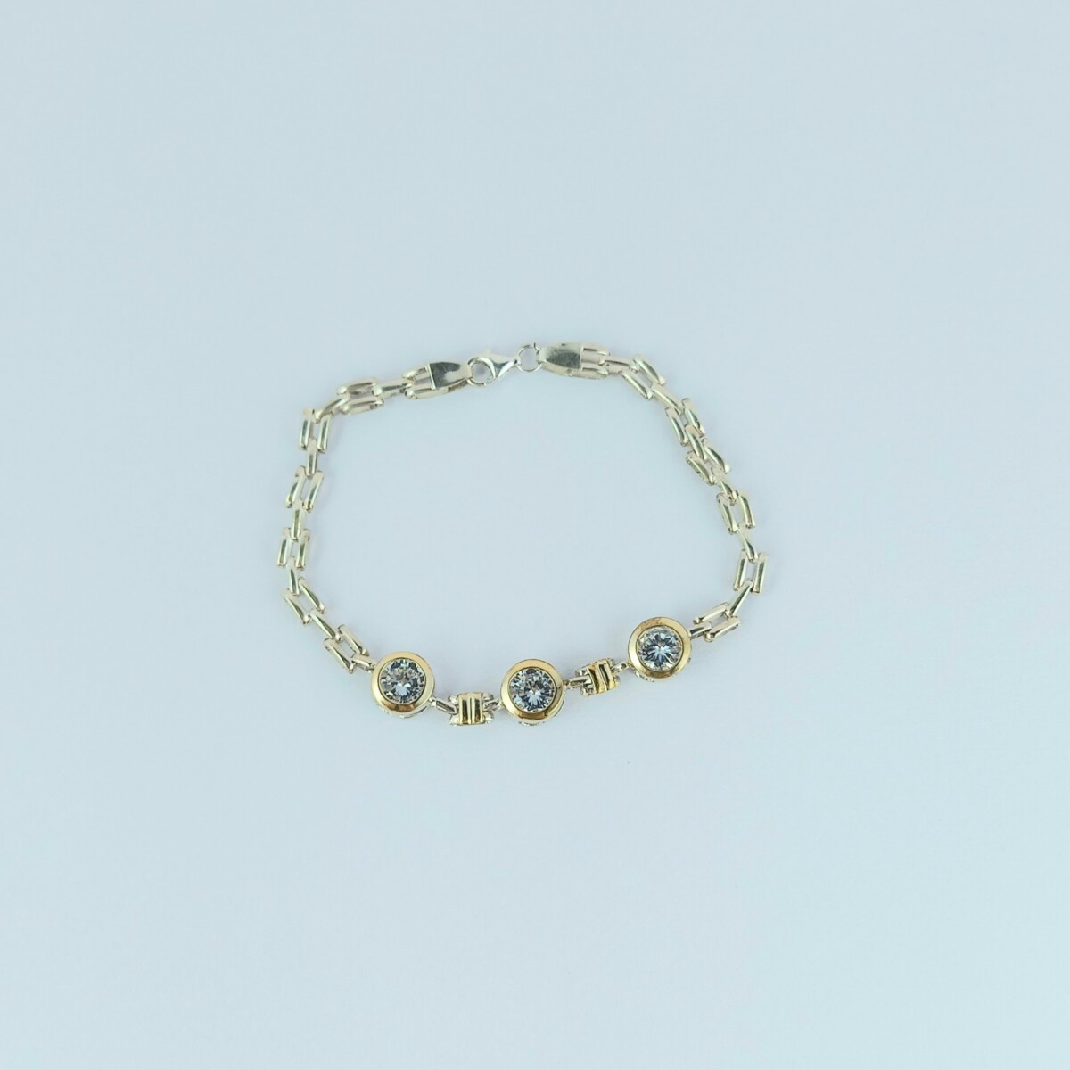 Pulsera de plata 925 y double en oro 18 ktes con circonias. 