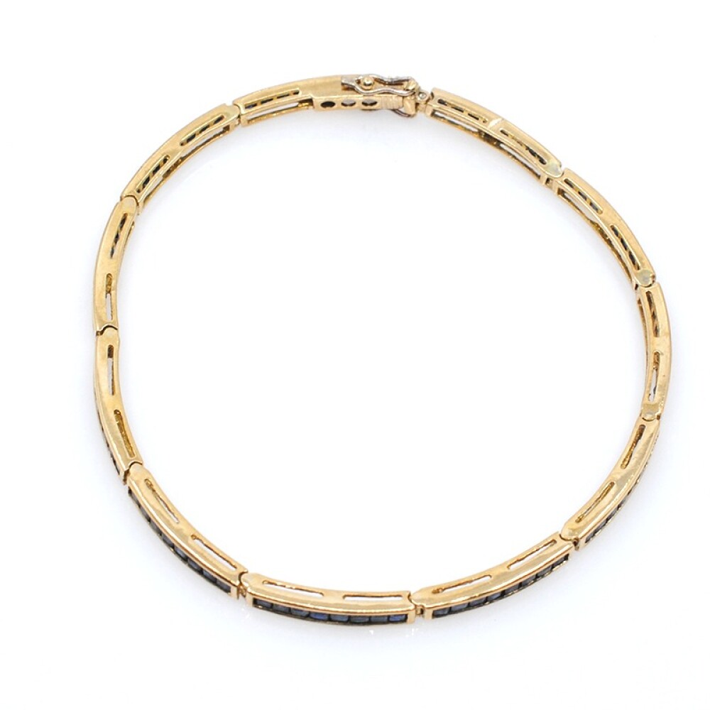 Pulsera articulada en oro 18k y zafiros azules. Pulsera articulada en oro 18k y zafiros azules.