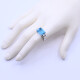 Anillo oro 18k blanco con topacio azul central y 4 brillantes baguette. Anillo oro 18k blanco con topacio azul central y 4 brillantes baguette.